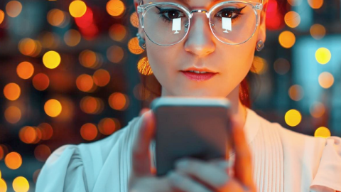 A woman looking at a phone screen